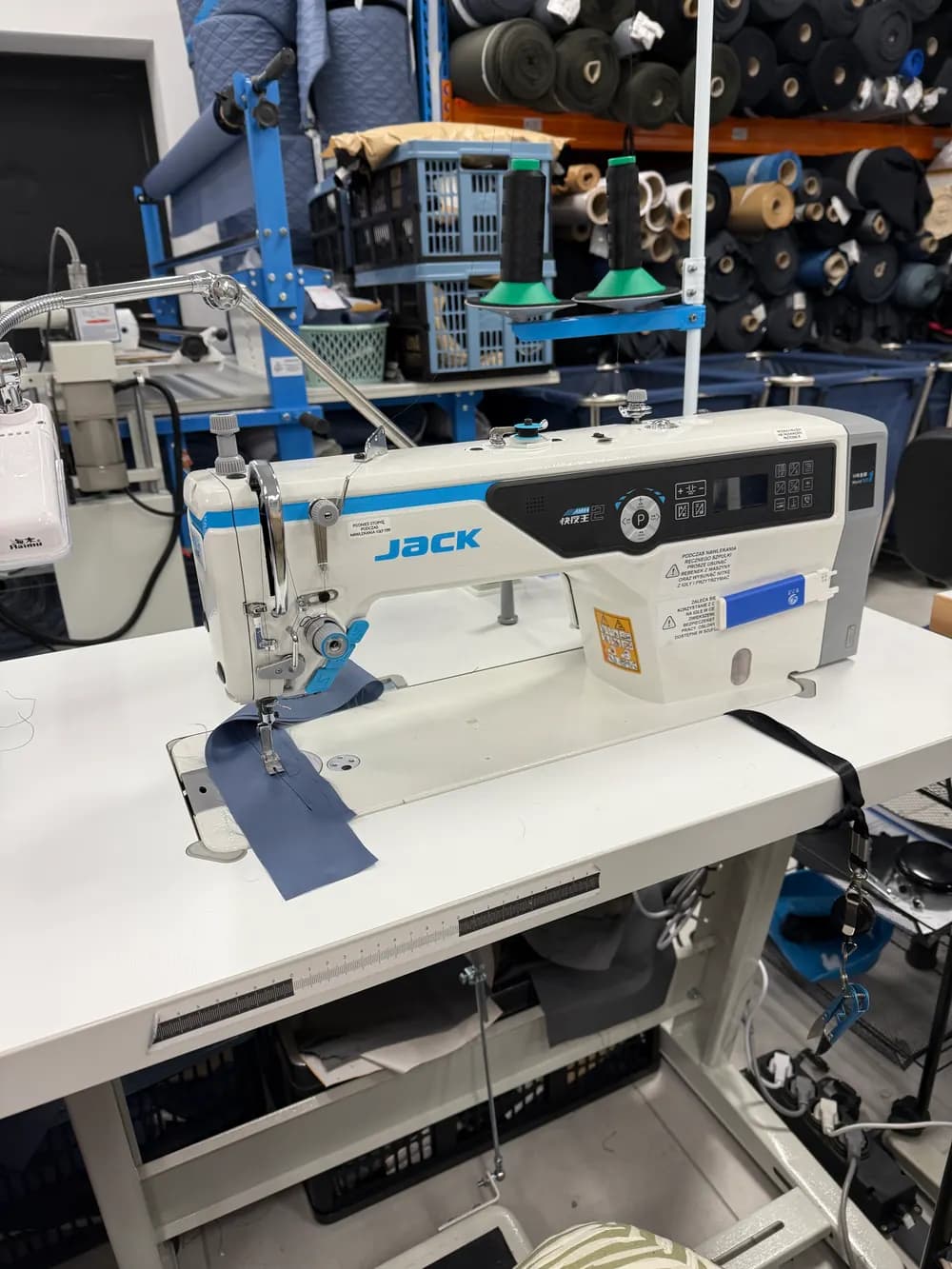A Jack lockstitch machine at a sewing workstation.