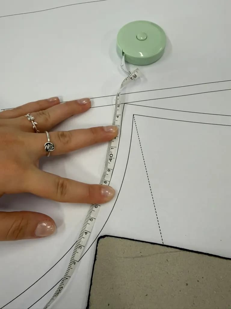 Checking a pattern with a measuring tape.