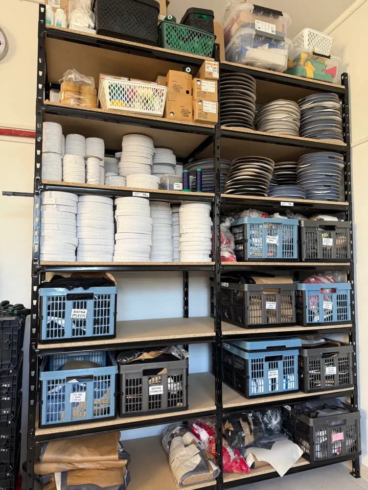 Materials and production components arranged on storage shelves.